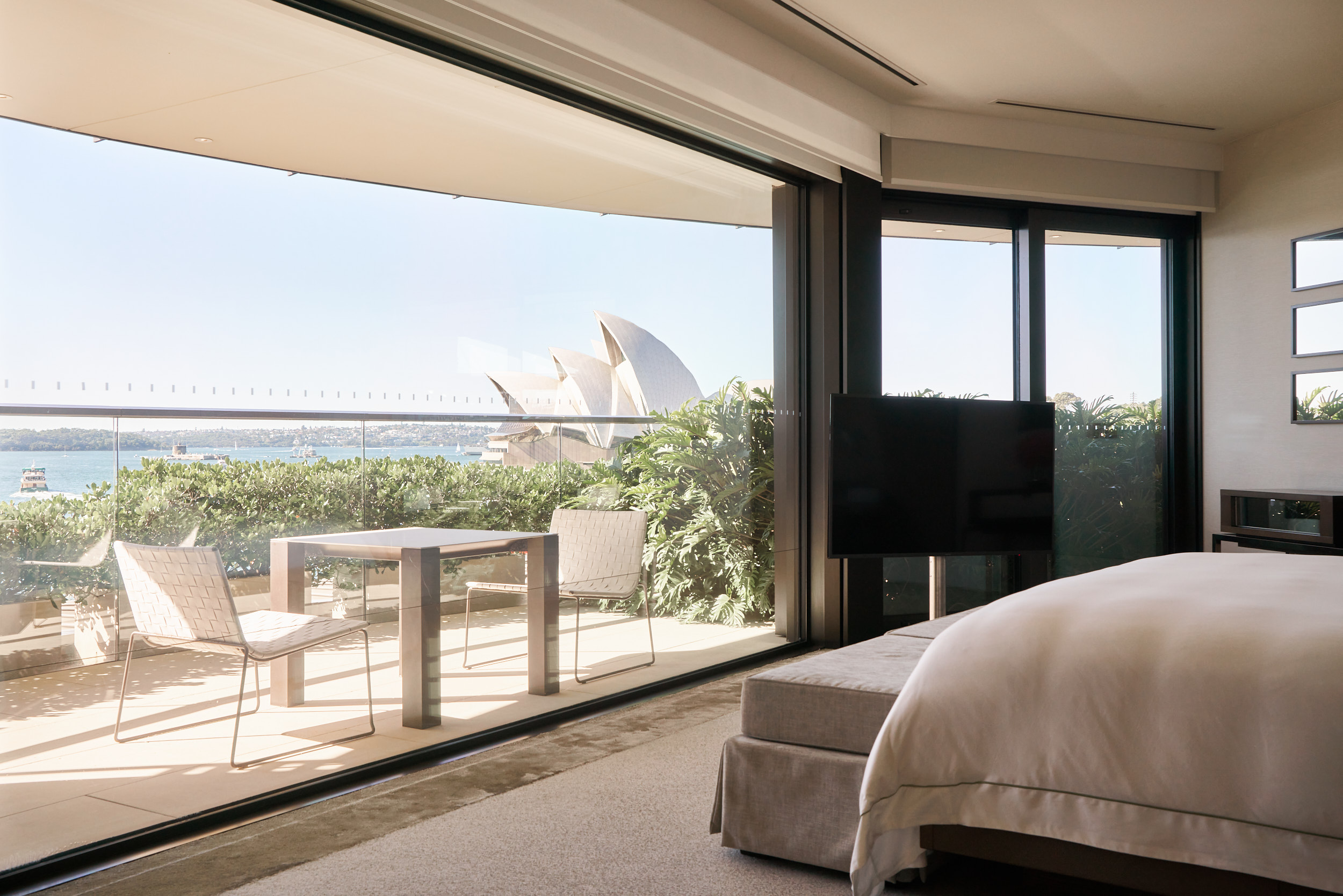 A wider room composition with the Opera House framed through the window.